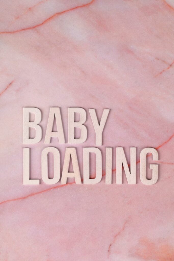 Pink marble textured background with 'Baby Loading' text in bold letters. Ideal for pregnancy announcement.